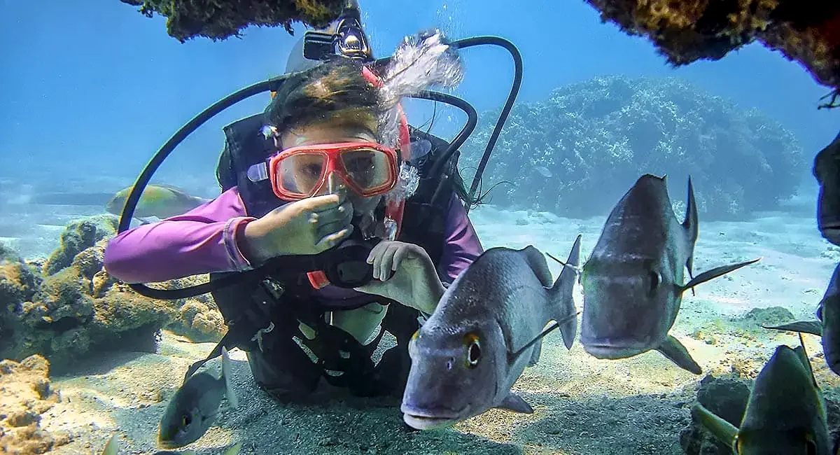 Diver equalizing ear pressure during a descent