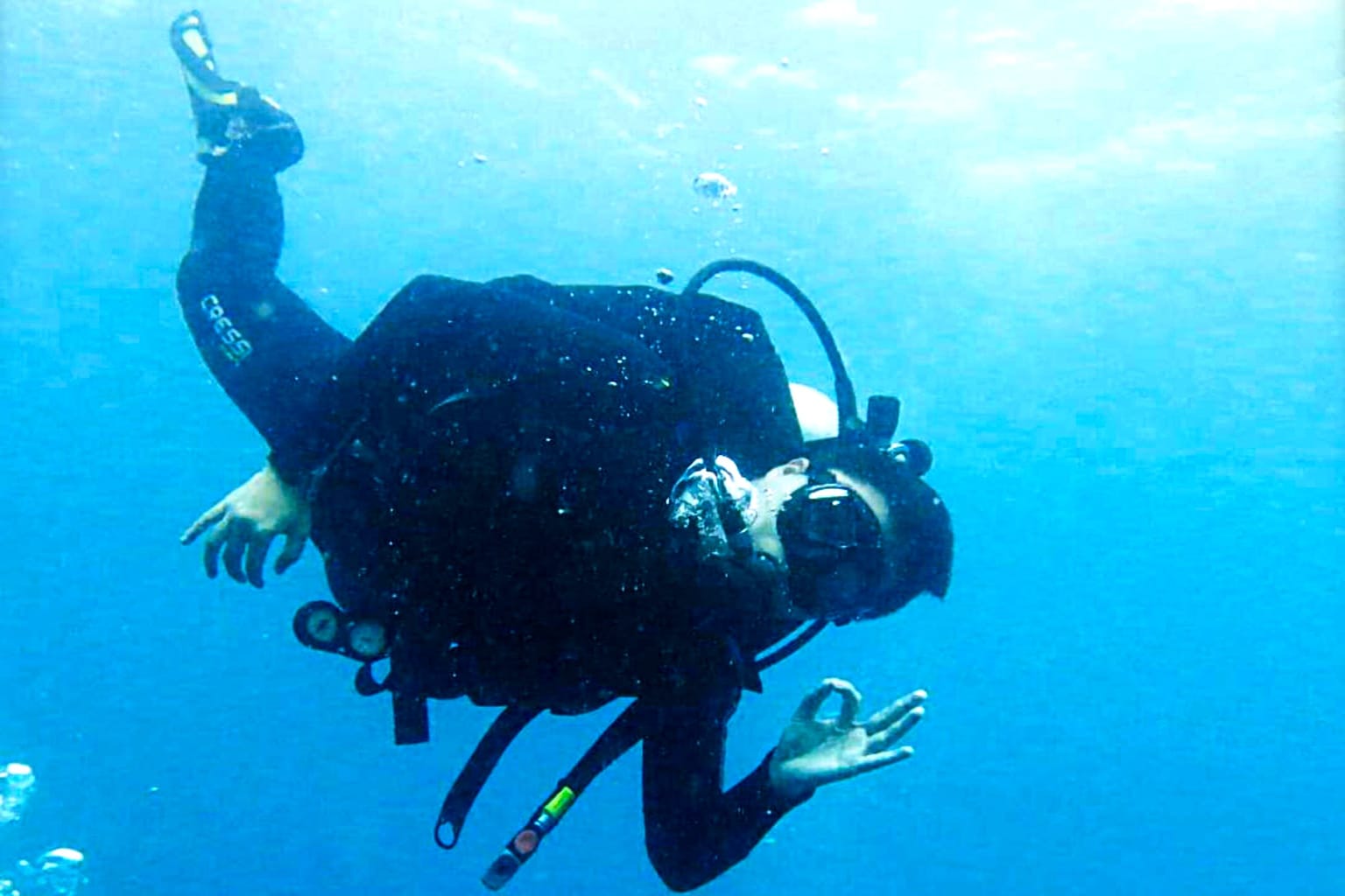 Nakula diver giving the OK sign in blue water